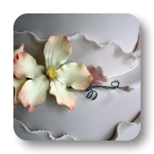 Shimmering Ivory Wedding Cake with Asymmetrical Ruffles.