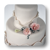 Shimmering Ivory Wedding Cake with Asymmetrical Ruffles.